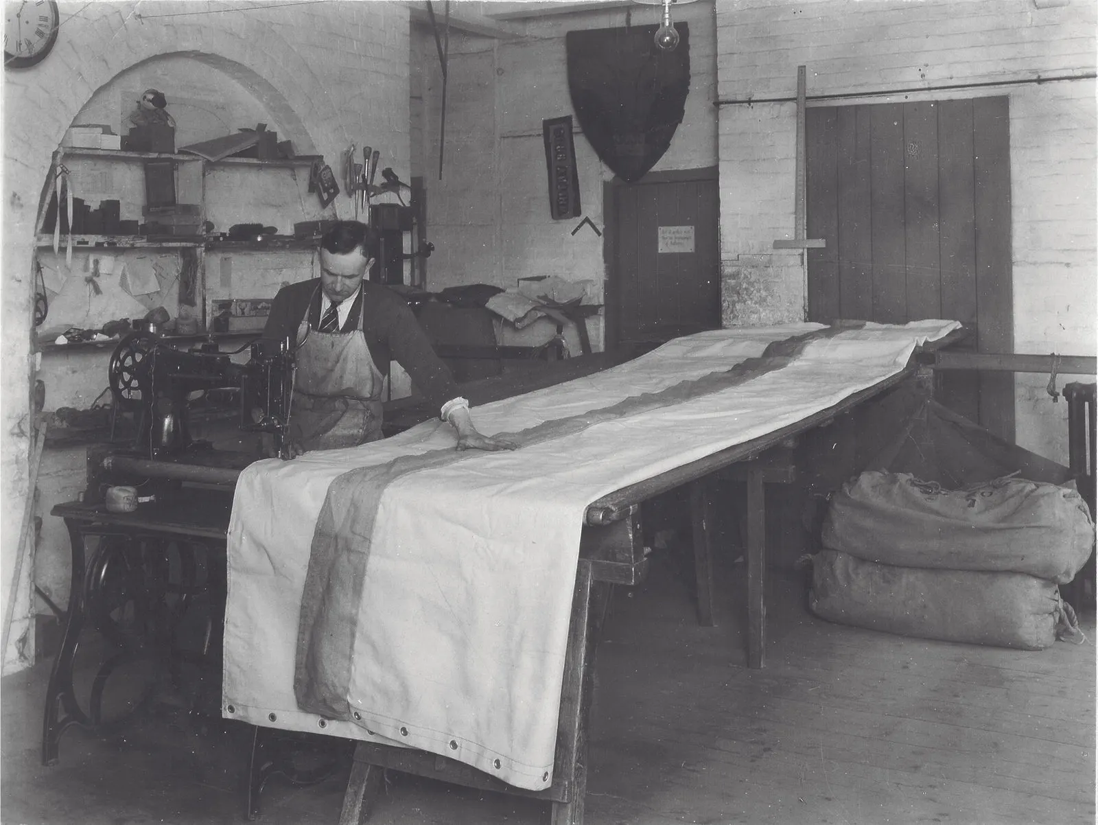 Archive photograph: a tentmaker at his bench working on canvas